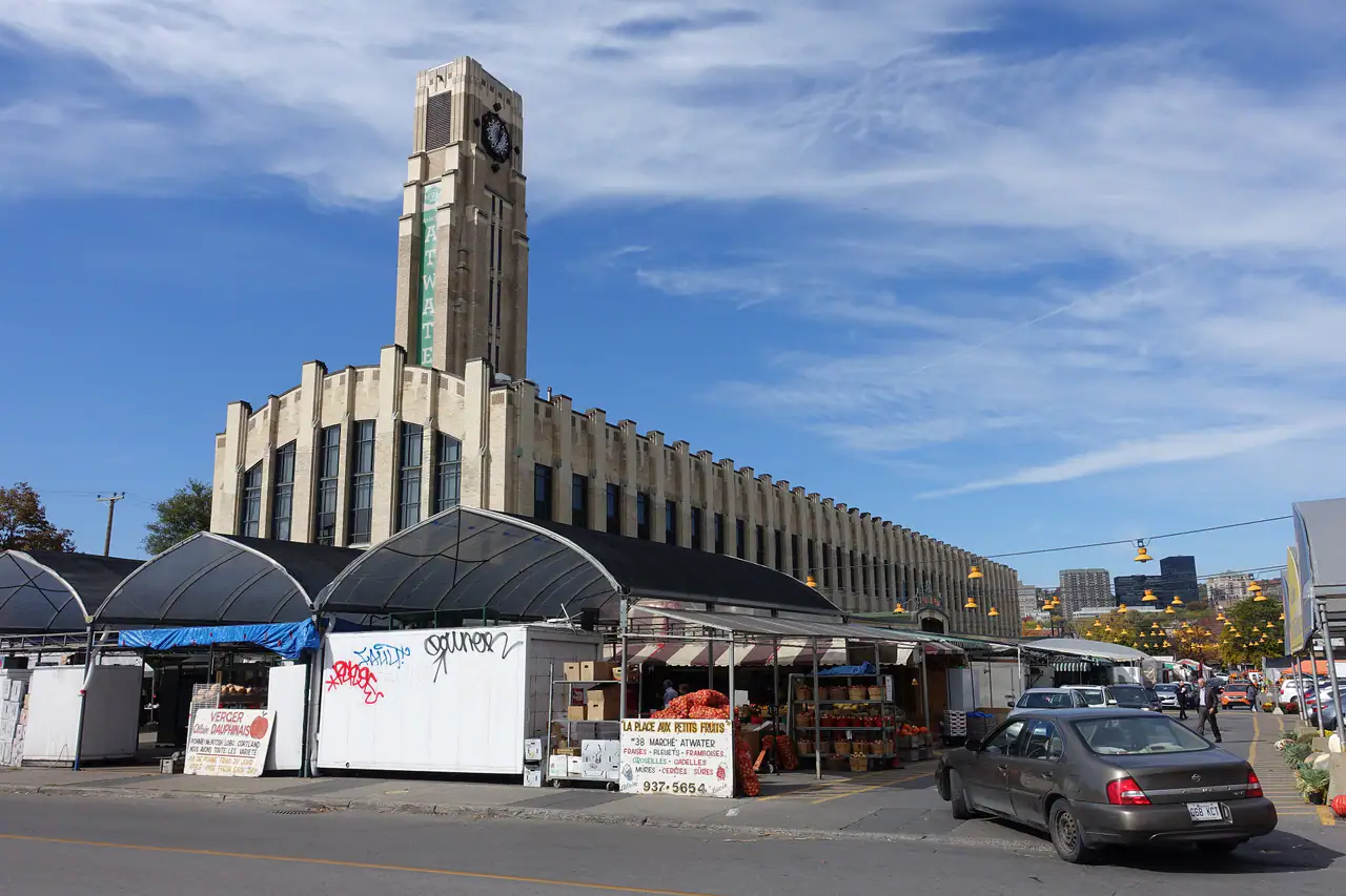 Atwater Market's Art Deco clock tower rising above the produce stalls and awnings on a clear day